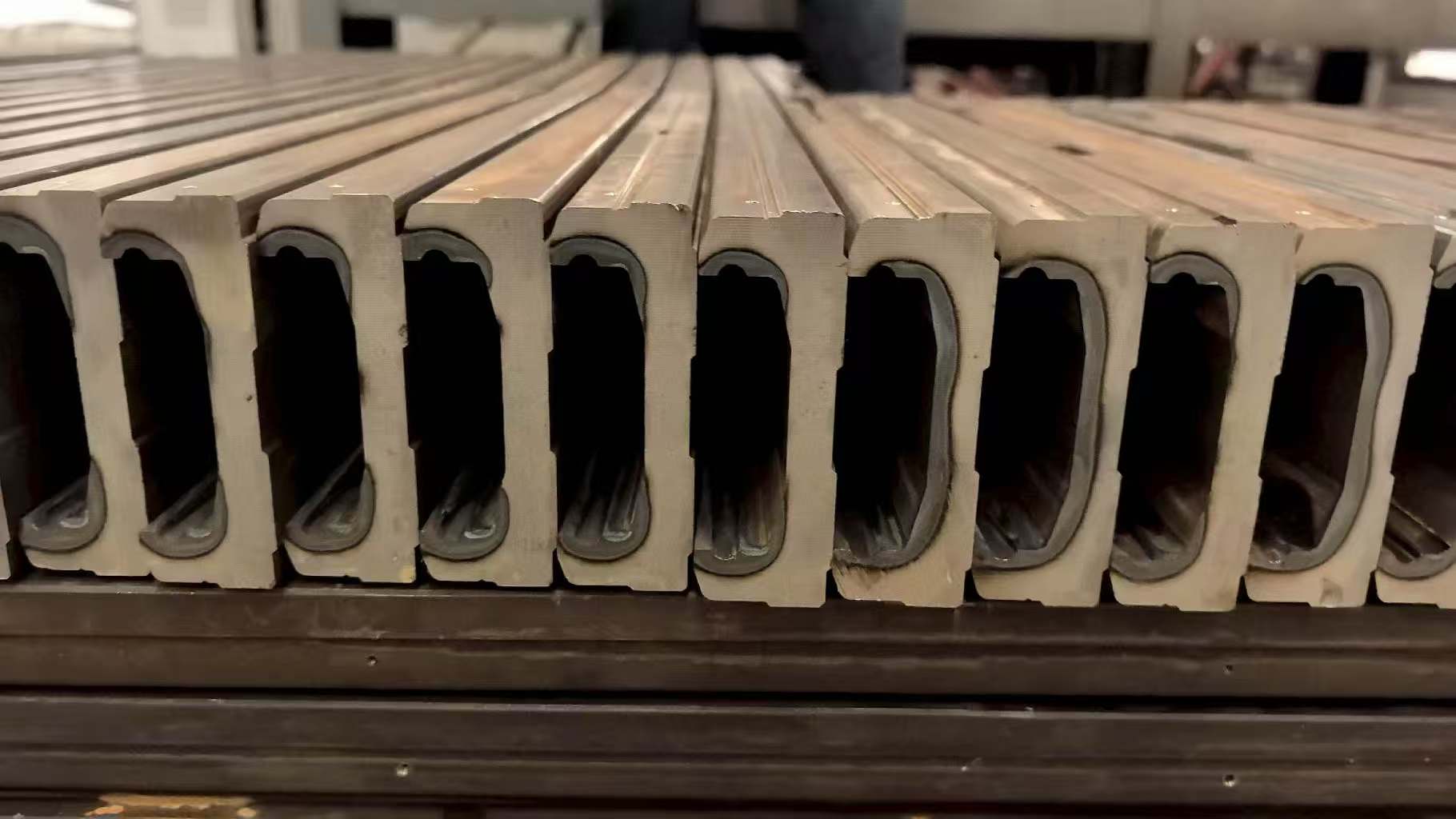 Rows of long hollow cold-drawn steel raw-profile blanks for downstream module manufacturing