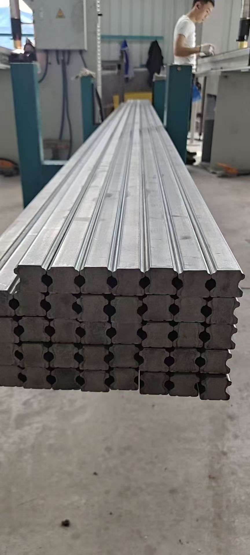Stacked long cold-drawn steel raw profiles for downstream module manufacturing viewed from their ends